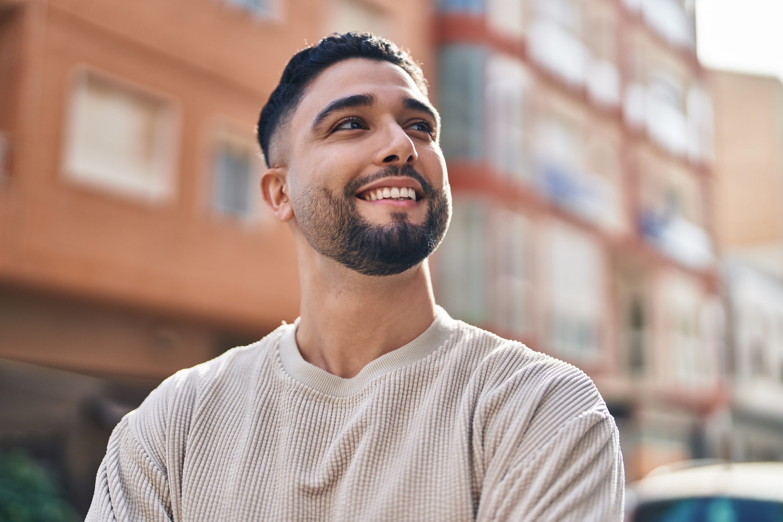 Smiling young man standing on a city street