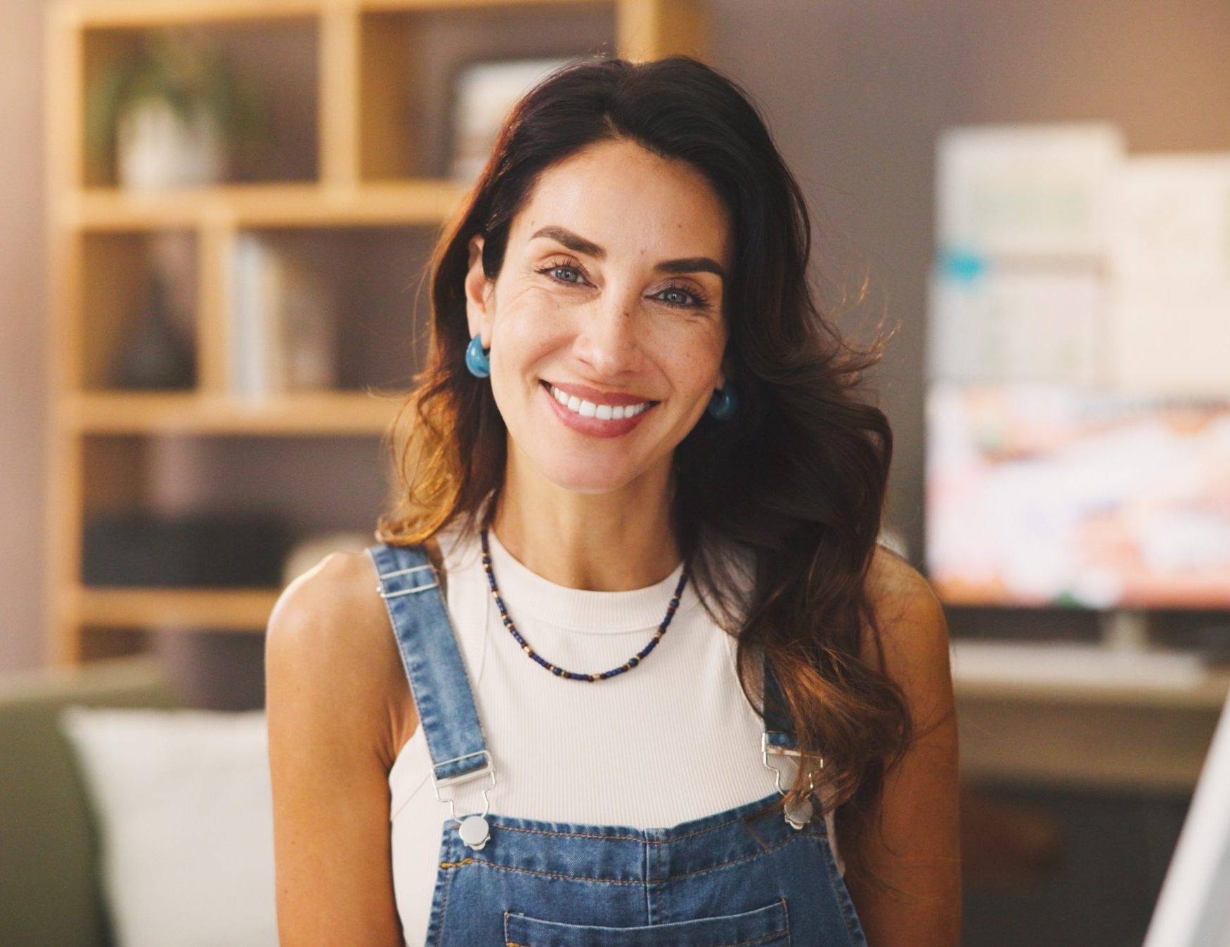 Smiling woman standing in a bright home office